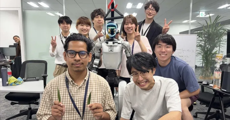 Students and engineers working on a humanoid robot